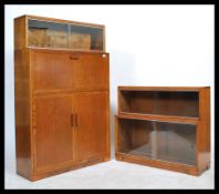 A 1930's Minty lawyers bureau bookcase. The sliding glass bookcase top over fall front bureau with