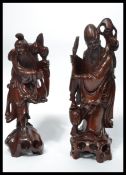 A pair of 19th century Chinese carved figures of Deity's raised on naturalistic bases. One