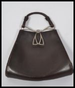 A vintage early 20th century Art Nouveau leather handbag having a white metal clasp. London makers
