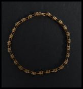 A hallmarked 9ct gold bracelet being set with white stones in a kiss link setting. Hallmarked