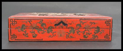 An early 20th century Chinese cinnabar lacquer box having a hard stone inset lid depicting vases and