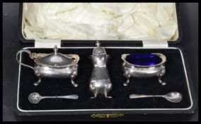 A vintage 20th century Regis plate silver plated condiment salt set in fitted case. Blue glass