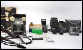A collection of vintage cameras and accessories such as lenses to include 35mm example please