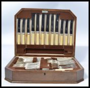 A vintage 20th Century oak cased canteen of cutlery by Walker and Hall, a six person setting