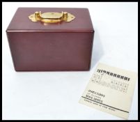A cased set of Chinese Mahjong game tiles in a brass handled set of drawers. 144 tiles present.