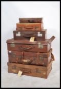 A collection of six graduating vintage 20th Century suitcases to include leather examples please