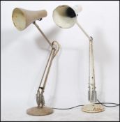 Two vintage 20th Century Herbert Terry Anglepoise desk / work lamps, raised on circular bases with