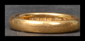 A hallmarked 22ct gold wedding band ring. Size I.5 weighs 5.3 grams.