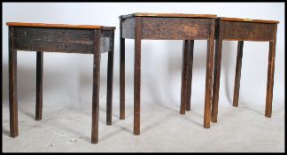 A collection of 3 early to mid 20th century wooden school desks. Each of square upright form being
