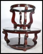 A pair of 20th century Chinese hard wood circular coffee tables, drop in central glass panels raised