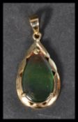 A hallmarked 14ct gold pendant set with a butterfly wing. Weight 2.9g.