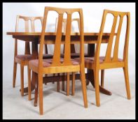 A 1970's Danish influence teak wood dining room suite to include extending dining table and chairs