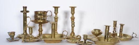 A good collection of brass chamber sticks and candle sticks dating from the 18th Century to