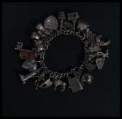 A hallmarked 925 silver charm bracelet having charms to include Adam and Eve within an apple,