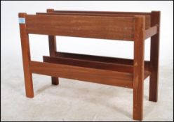 A 1970's Danish teak wood retro magazine rack - Canterbury by Guy Rogers. The panelled body with