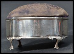 An early 20th century silver hallmarked box having a pin cushion lid raised on cabriole leg. Hunting