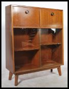 A 1960's / mid century teak wood cocktail cabinet having hinged top with appointed interior and