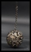 A 19th century Chinese silver incense ball / puzzle ball depicting dragons chasing the flaming