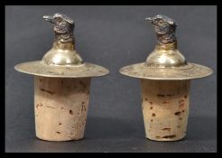 A pair of silver hallmarked wine bottle cork stoppers, each adorned with pheasant heads - hunting