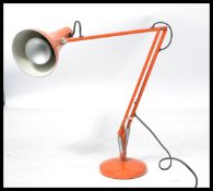 A retro 20th century Herbert Terry anglepoise industrial desk lamp with conical shade raised on a
