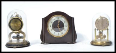 A collection of clocks to include a Schatz brass anniversary clock, a Bentimo anniversary clock,