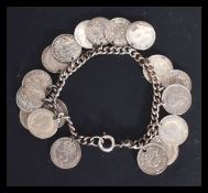 A sterling silver / 925 charm bracelet having eighteen silver 3p coins attached with examples dating