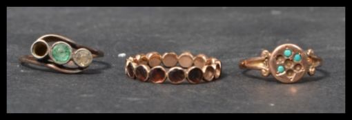 A group of three 9ct gold antique rings to include a three stone crossover ring with green and white