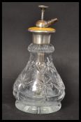 An early 20th century Art Deco silver and glass perfume bottle atomizer having a yellow enamel