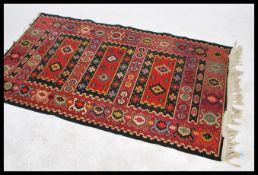 A vintage 20th century floor rug having a run of three central rectangular geometric panels within