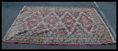 A vintage floor rug on sky blue ground central medallions with geometric borders.