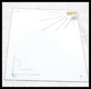 A 1930's style art deco frameless wall mirror of square form being acid etched with sunburst