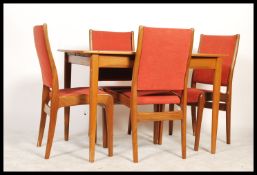 A retro 1960's teak wood extending dining table of rectangular form by Mcintosh having an