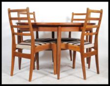 G-Plan - A retro 1960's teak wood extending dining table of round form raised on tapering legs