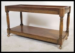 A Victorian 19th century oak two tier buffet - butlers trolley. Raised on castors having block and