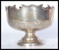 An early 20th century silver hallmarked punch bowl / centerpiece raised on a stepped circular base