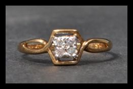 A hallmarked 9ct gold and white stone ring having four white stones in a Art Deco style setting.