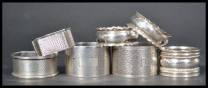 A group of seven silver hallmarked napkin rings to include a pair dated Birmingham 1924 , one with a