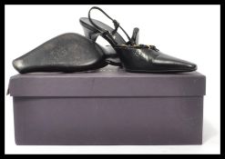 A pair of original designer ladies black leather backless  evening shoes by Prada, retaining