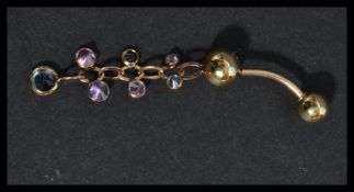 A 9ct gold belly button ring having pastel coloured stone set dangles. Marked 375 tests 9ct gold.