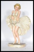 A cast metal doorstep in the form of a figure of Marilyn Monroe in the iconic pose. Measures 34 cm