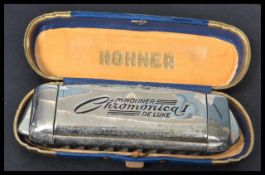 A vintage 20th Century Art Deco cased M. Hohner Chromonica I De - Luxe harmonica. Measures 15 cm
