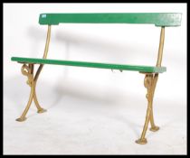 A 19th century cast iron and wooden painted bench, possibly ex tram bench. The gilded cast iron