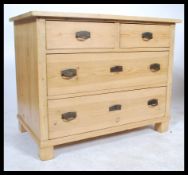 A 20th Century Scandinavian pine two short over two long chest of drawers having pressed metal art