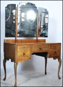 A 20th century Edwardian walnut dressing table having an arrangement of drawers with a three fold