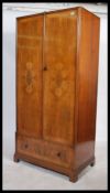 A 1930's Art Deco walnut single wardrobe  armoire in the manner of Compactom. The robe being