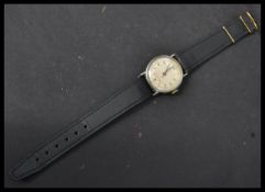 A vintage mid 20th century Dustproof wristwatch having a silvered dial with faceted hands and red