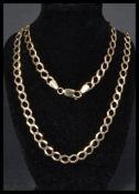A hallmarked 9ct gold curb link necklace chain having a lobster claw clasp. Hallmarked Birmingham.