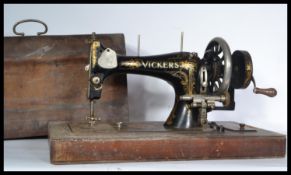 A late 19th Century Victorian hand crank sewing machine by Vickers, gilt detailing to the body