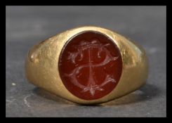 A hallmarked 18ct gold early 20th century intaglio ring set with a carnelian having carved