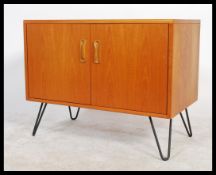 A retro 20th Century G-Plan teak wood media cabinet, the two door cabinet having shelved interior